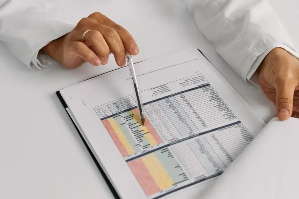 A veterinarian going over a lab results printout with a dog owner